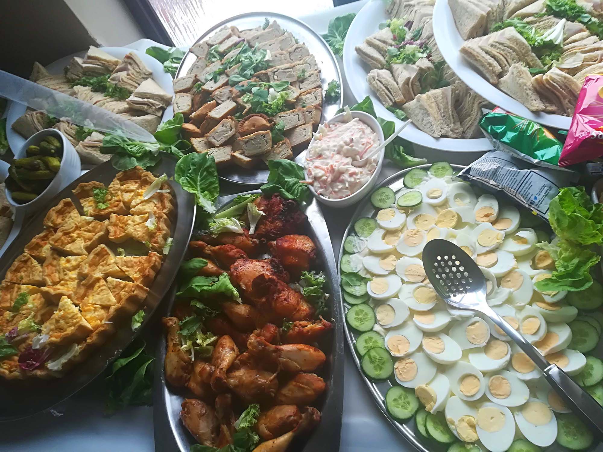 selection of pies, quiche and drumsticks at a catering event